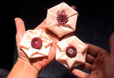 Top: Pinwheel Hexie with whip-stitched flat button *** Left: Flower Hexie with fabric-covered four-hole button *** Right: Flower Hexie with button-decorated, rimmed one-hole button