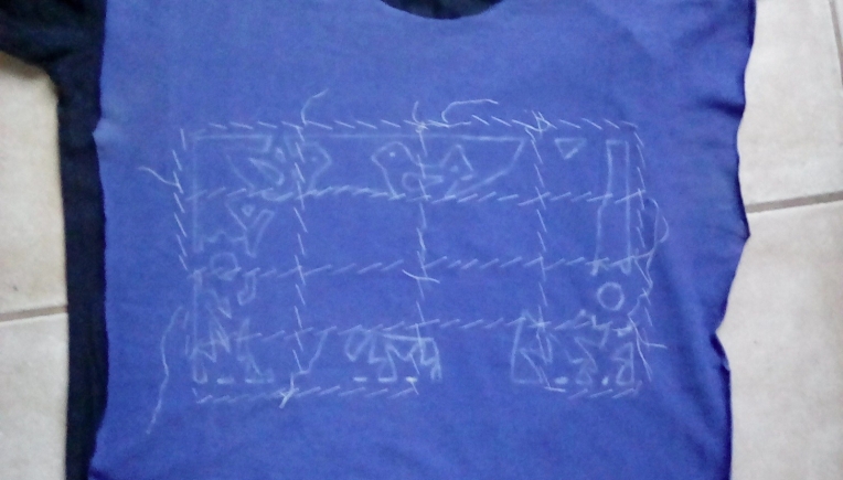 My first Mystery Project 2018: 2 old T-shirts, a partial design sketched with chalk, basted and ready to be stitched. What am I working on? :)